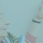 woman adjusting thermostat