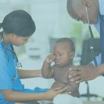 pediatrician and nurse examining a baby boy in clinic